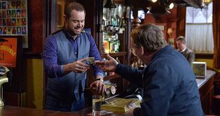 The regulars are in uproar and vow to help raise the money to save The Queen Vic which is exactly what Mick was hoping for. Ian gives a donation to Mick. Mick Carter, Ian Beale in Eastenders.