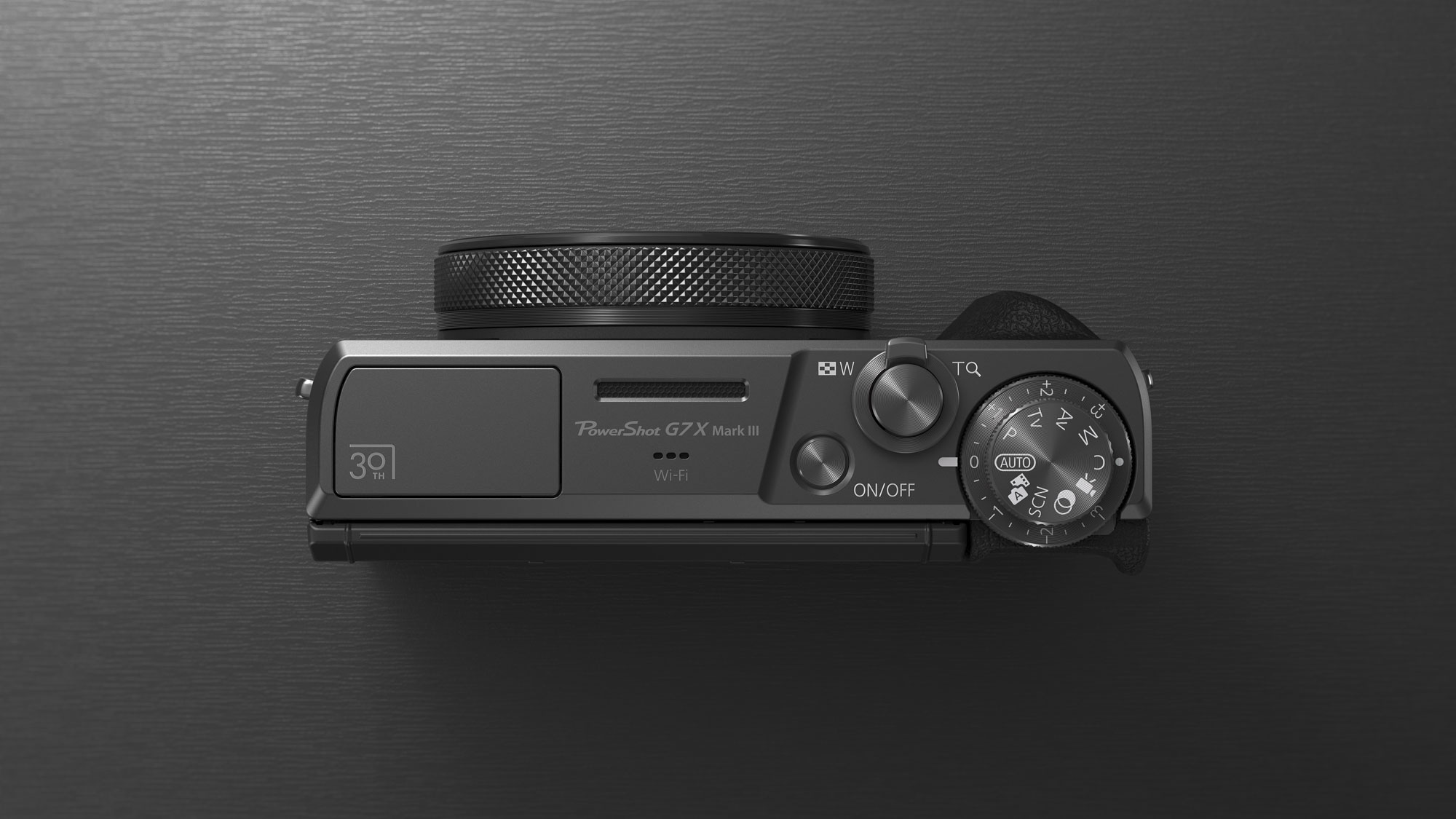Top plate of the Canon PowerShot G7 X Mark III Anniversary Edition in graphite, on a graphite-type surface