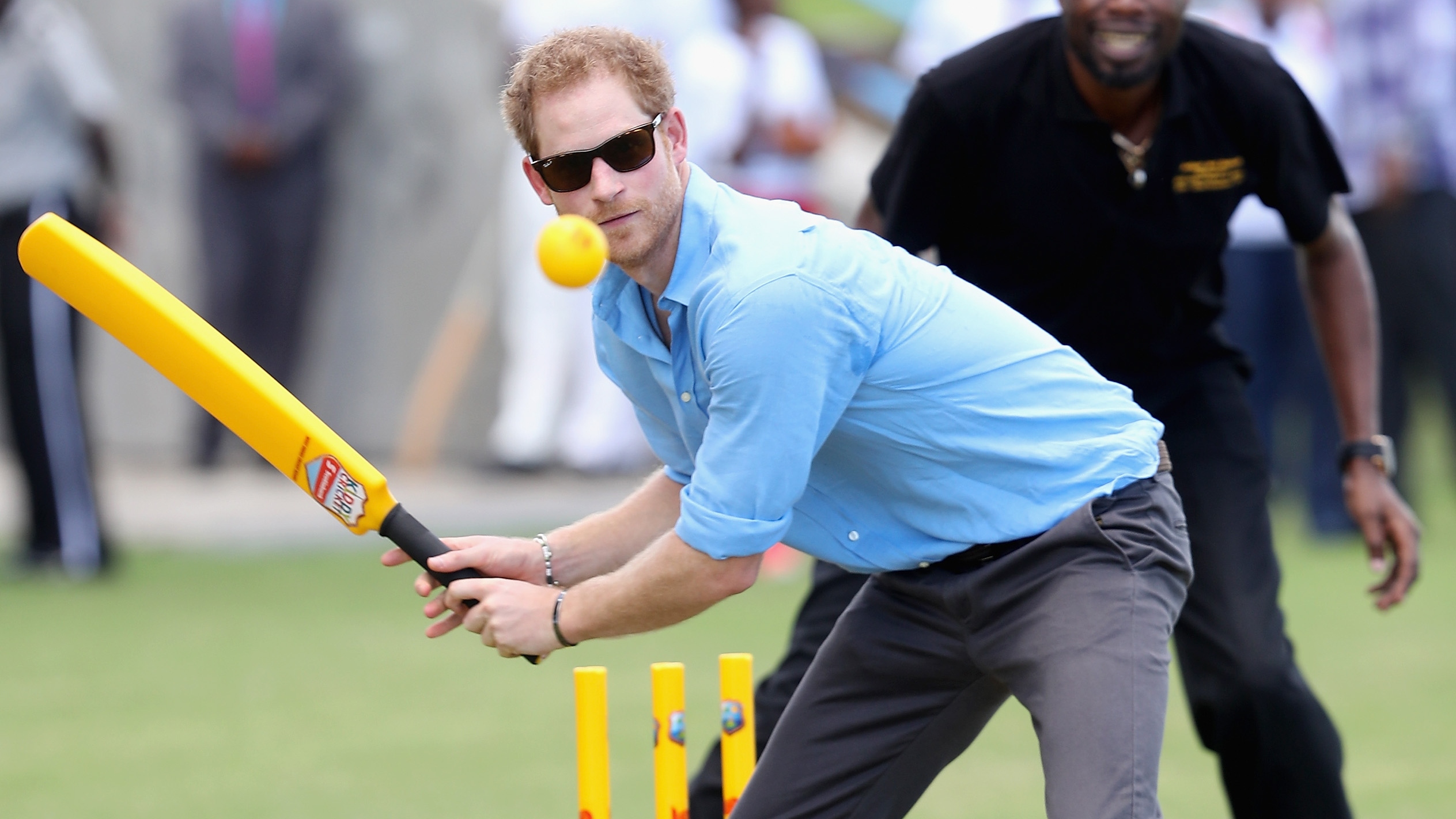 Prince Harry plays cricket as he attends a youth sports festival at Sir Vivian Richards Stadium on November 21, 2016