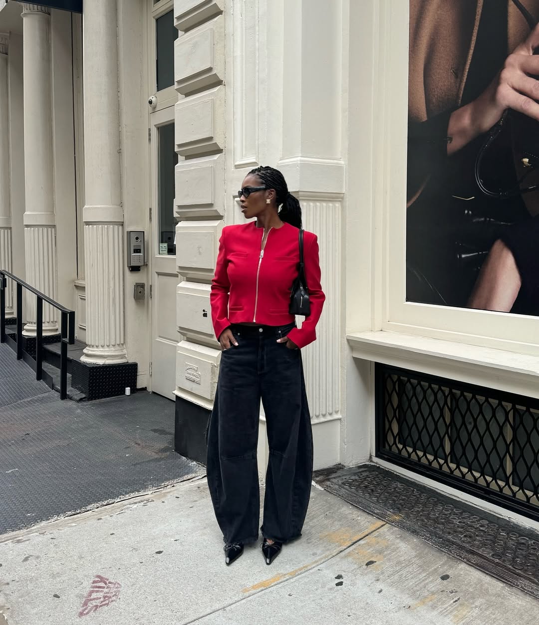 @nlmarilyn wears black barrel-leg jeans red jacket