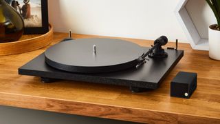 A2D2 Stream beside a black turntable, on a wooden table