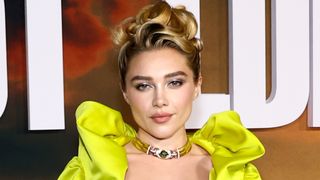 Florence Pugh attends Netflix's "East Of Eden" New York Premiere at The Plaza Hotel on September 30, 2026 in New York City. She's wearing a chartreuse corest top with huge soulders and a grey skirt.