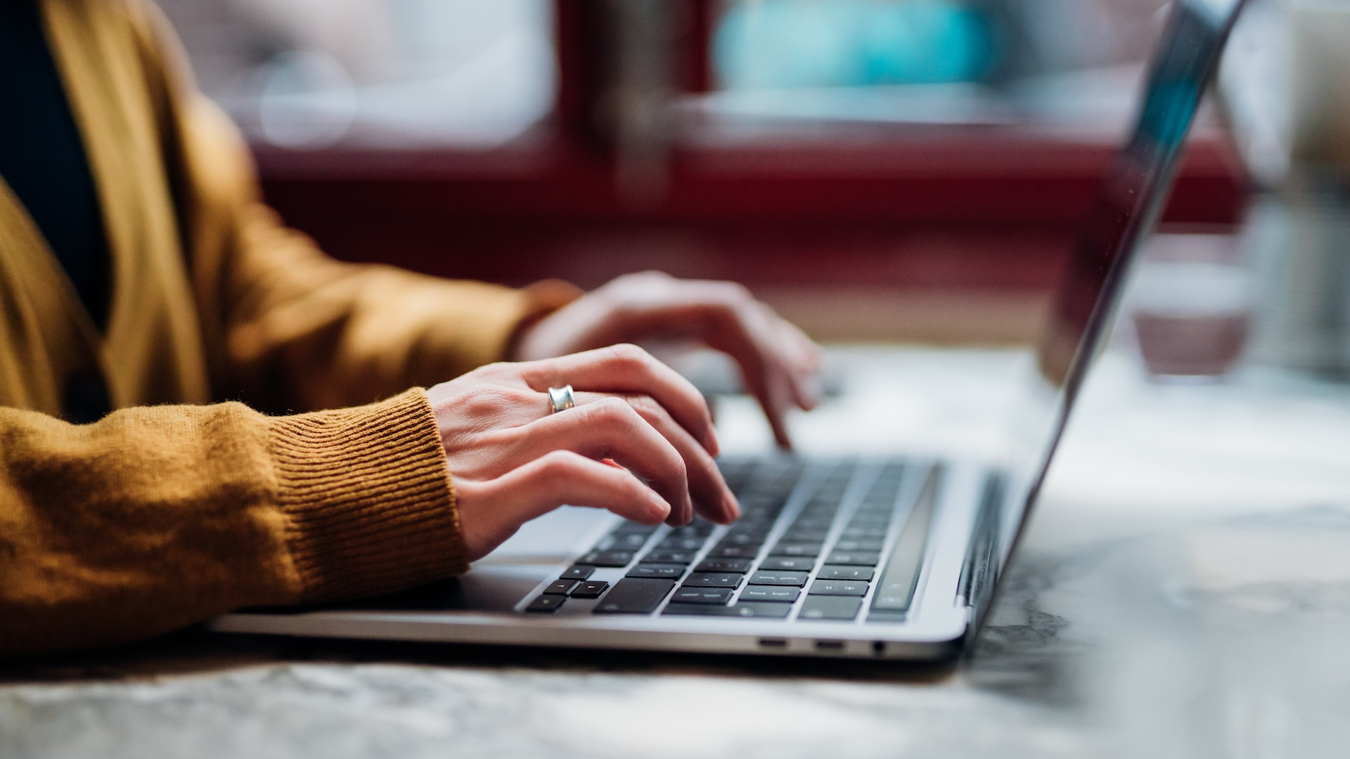 Woman typing at laptop