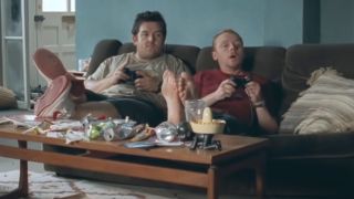 Nick Frost and Somon Pegg sitting on a couch playing video games in Shaun Of The Dead