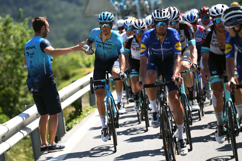 LEUKERBAD SWITZERLAND JUNE 10 Jakob Fuglsang of Denmark and Team Astana Premier Tech during the 84th Tour de Suisse 2021 Stage 5 a 1752km stage from Gstaad to Leukerbad 1385m Feed Zone Feeding Soigneur Tacx bottle UCIworldtour tds tourdesuisse on June 10 2021 in Leukerbad Switzerland Photo by Tim de WaeleGetty Images