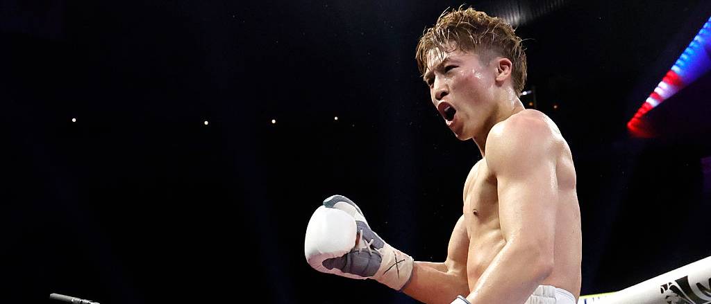 Naoya Inoue celebrates retaining his undisputed super bantamweight world title against Ramon Cardenas