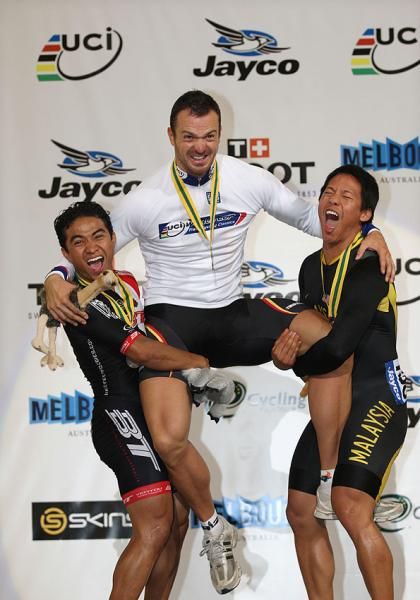 Azizulhasni Awang and Josiah Ng hoist Carsten Bergemann (Germany) aloft on the men's keirin podium.
