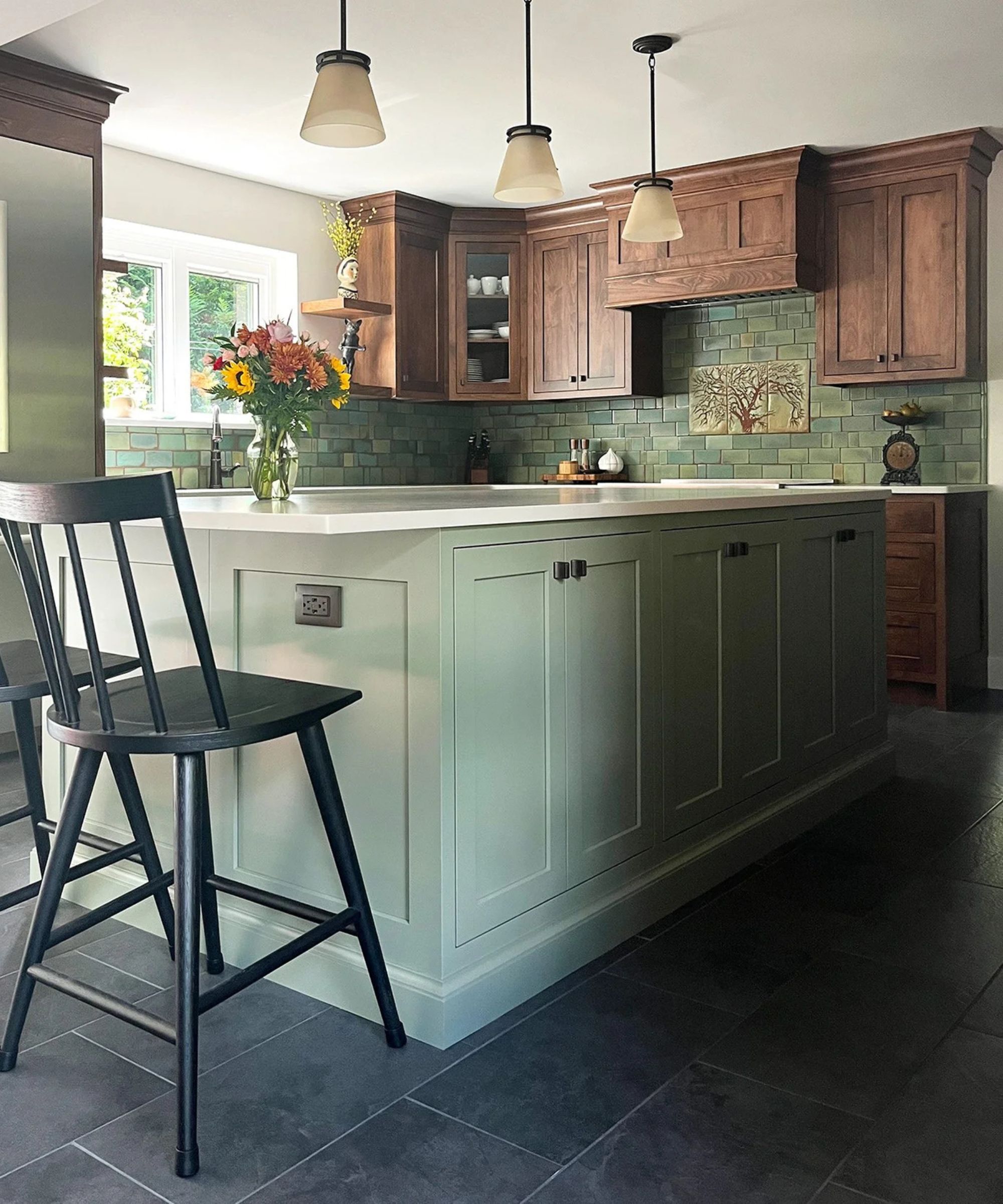 A craftsman kitchen with wooden cabinets and a green island