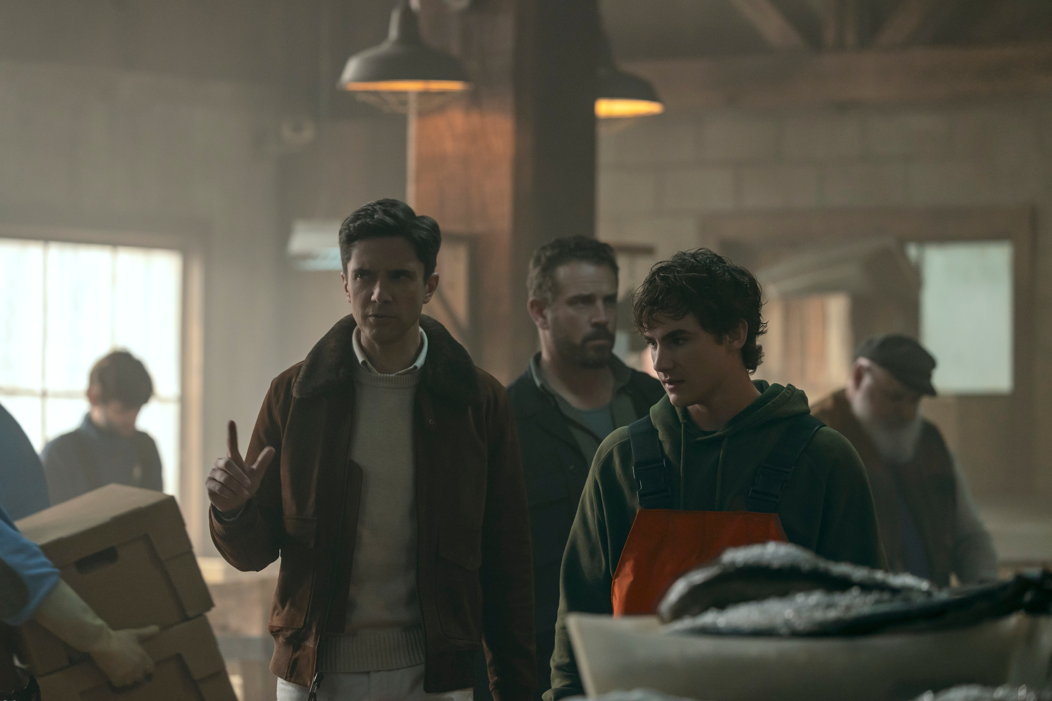 Topher Grace as Grady, Josh Crotty as Nate and Brady Hepner as Diller Hopkins walking through a fish market in the waterfront