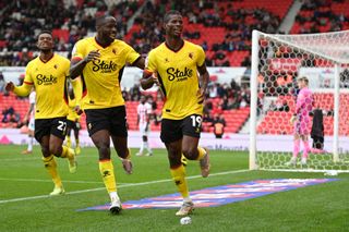 Vakoun Issouf Bayo of Watford celebrates their sides fourth goal with team mate Keinan Davis during the Sky Bet Championship between Stoke City and Watford at Bet365 Stadium on October 02, 2022 in Stoke on Trent, England.