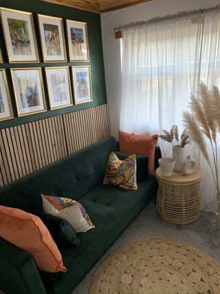 After of room with gallery wall, green couch with orange sofas and neutral floor with sheer voile