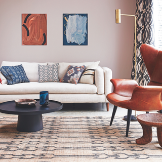 red and cream print rug on cream carpet in red and cream living room