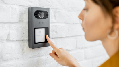 Best video doorbells: Image depicts woman ringing video doorbell