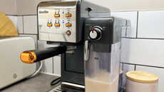 Image of the Breville One-Touch CoffeeHouse Machine in a bright white and neutral kitchen