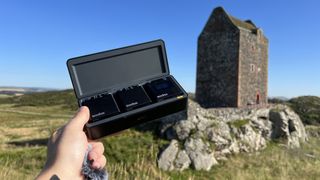 Godox Virso/Virso S microphone held up by a hand in a field