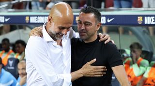 Pep Guardiola and Xavi embrace ahead of a charity match between Barcelona and Manchester City in August 2022.