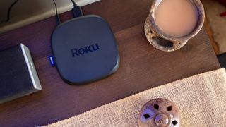 The top of the Roku Ultra (2024) on a TV table