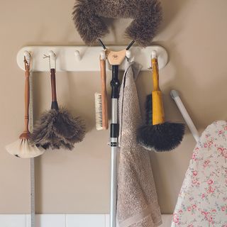 cream wall with towel on wall hooks