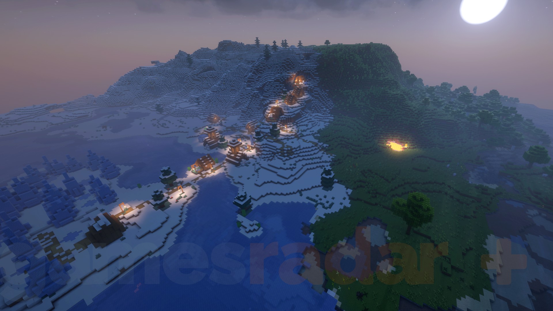 Lights shine from a Minecraft village as night descends on the overworld.