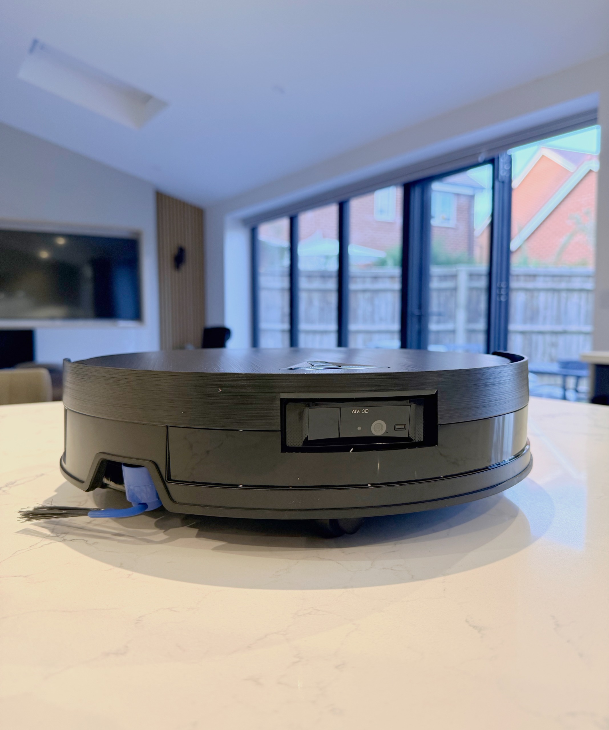 Front view of ECOVACS DEEBOT X11 OmniCyclone showing AIVI 3D sensors and side brush