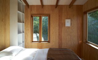 Interior of cabin with wooden walls and bed