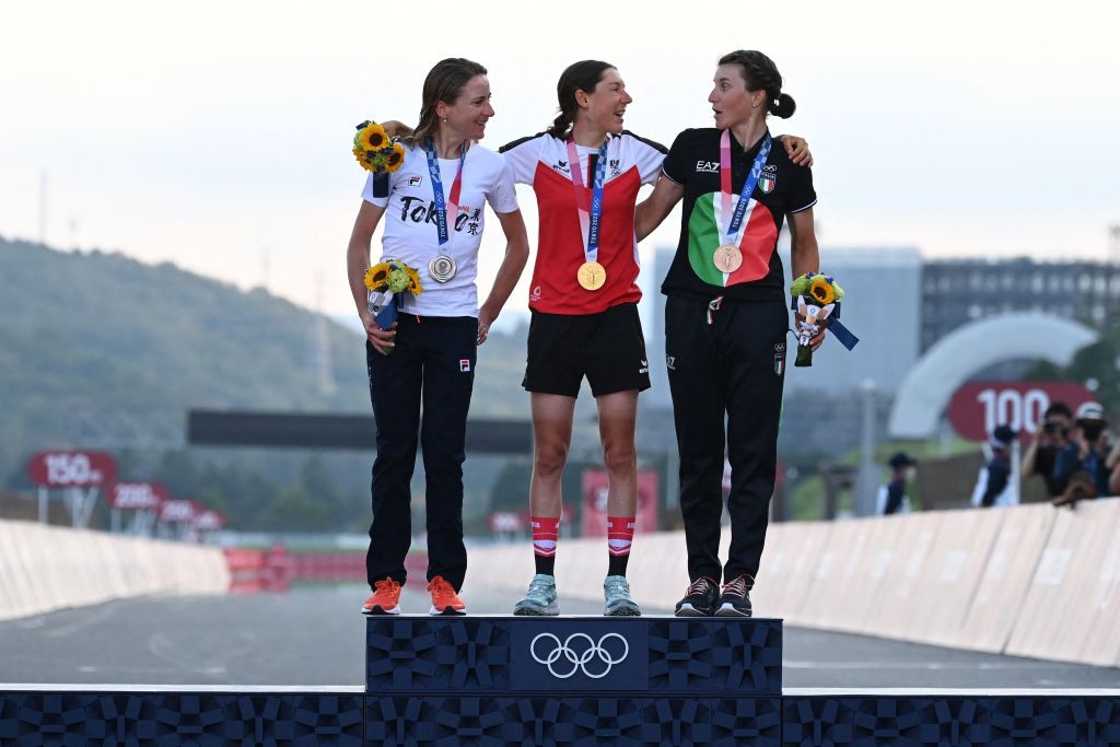 LR Silver medallist Netherlands Annemiek Van Vleuten Gold medallist Austrias Anna Kiesenhofer and bronze medallist Italys Elisa Longo Borghini pose for pictures on the podium during the medal ceremony for the womens cycling road race of the Tokyo 2020 Olympic Games at the Fuji International Speedway in Oyama Japan on July 25 2021 Photo by Greg Baker AFP Photo by GREG BAKERAFP via Getty Images