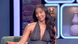 Taylor Hale wears a black halter top and is mic'd up while analyzing Season 28 of Big Brother.