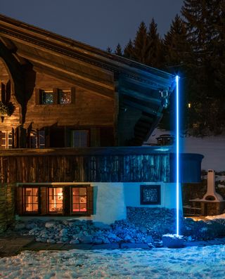The chalet is lit up outside by a site-specific neon installation