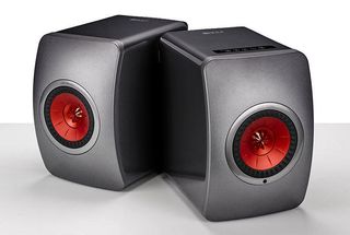 Two KEF LS50 Wireless speakers on a grey background