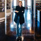 A picture of Jennifer Williams wearing blue jeans and a black jacket in an organized closet