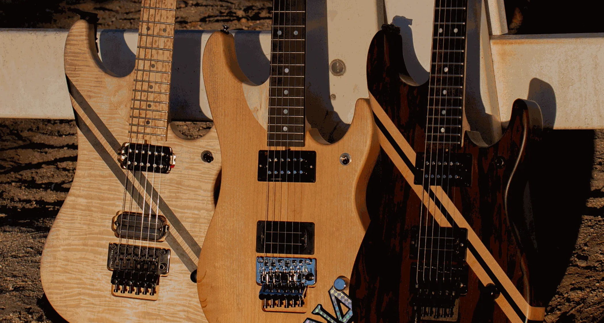 Nuno Bettencourt launches his own guitar company, and poses with his new models against a fence.