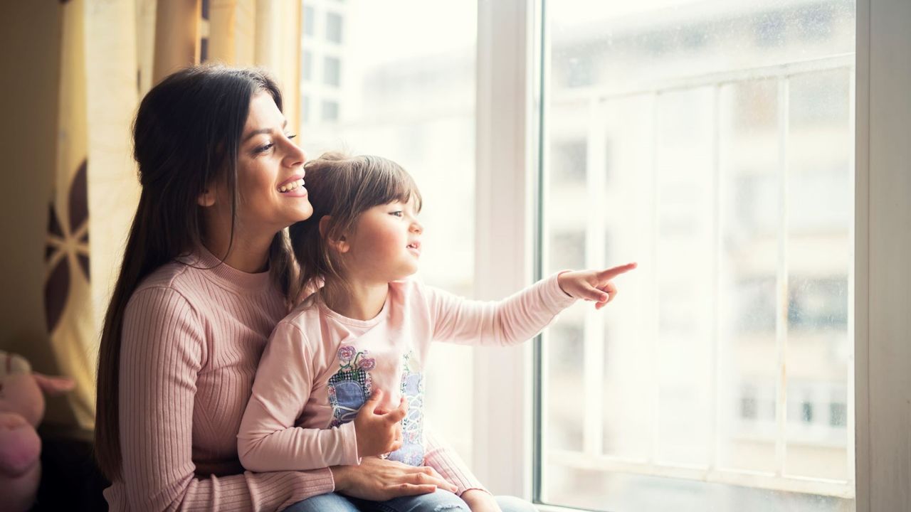 Mum and child looking out the window