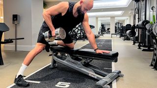 Calum Sharma, personal trainer at the Body Lab, performs the top position of a dumbbell row