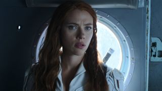 Black Widow in her white suit talking to Alexi in the back of a helicopter