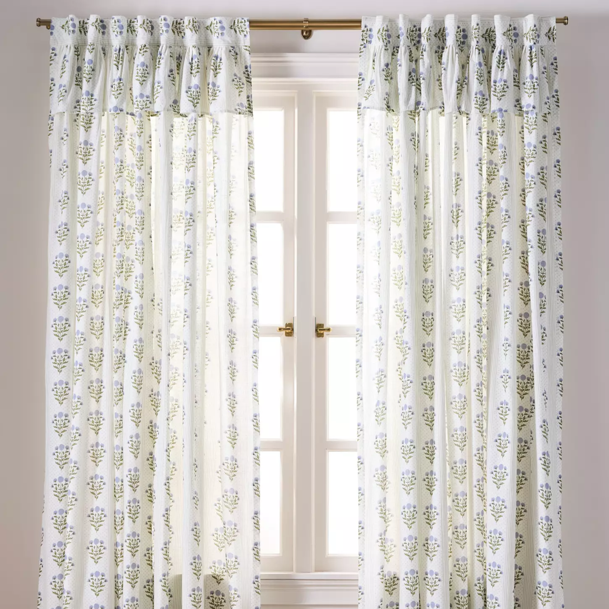 a set of floral curtains in front of a window