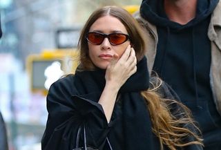 Ashley Olsen in an all-black outfit and The Row Lady bag, walks with Nicolas Turko in New York City