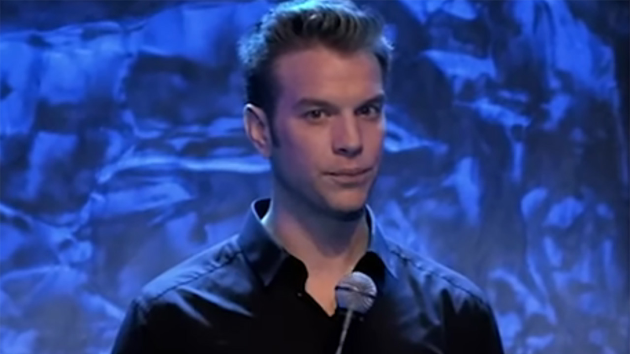 Anthony Jeselnik looks at the camera while telling a joke about virtue signaling on Netflix.