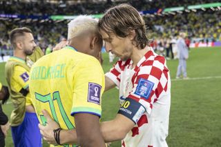 Rodrygo is consoled by Real Madrid team-mate Luka Modric after his penalty miss in Brazil's World Cup semi-final loss to Croatia at Qatar 2022.