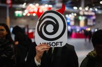 A visitor holds a mask of Ubisoft during the Paris Games Week fair in Paris, on October 23, 2024. (Photo by Dimitar DILKOFF / AFP) (Photo by DIMITAR DILKOFF/AFP via Getty Images)