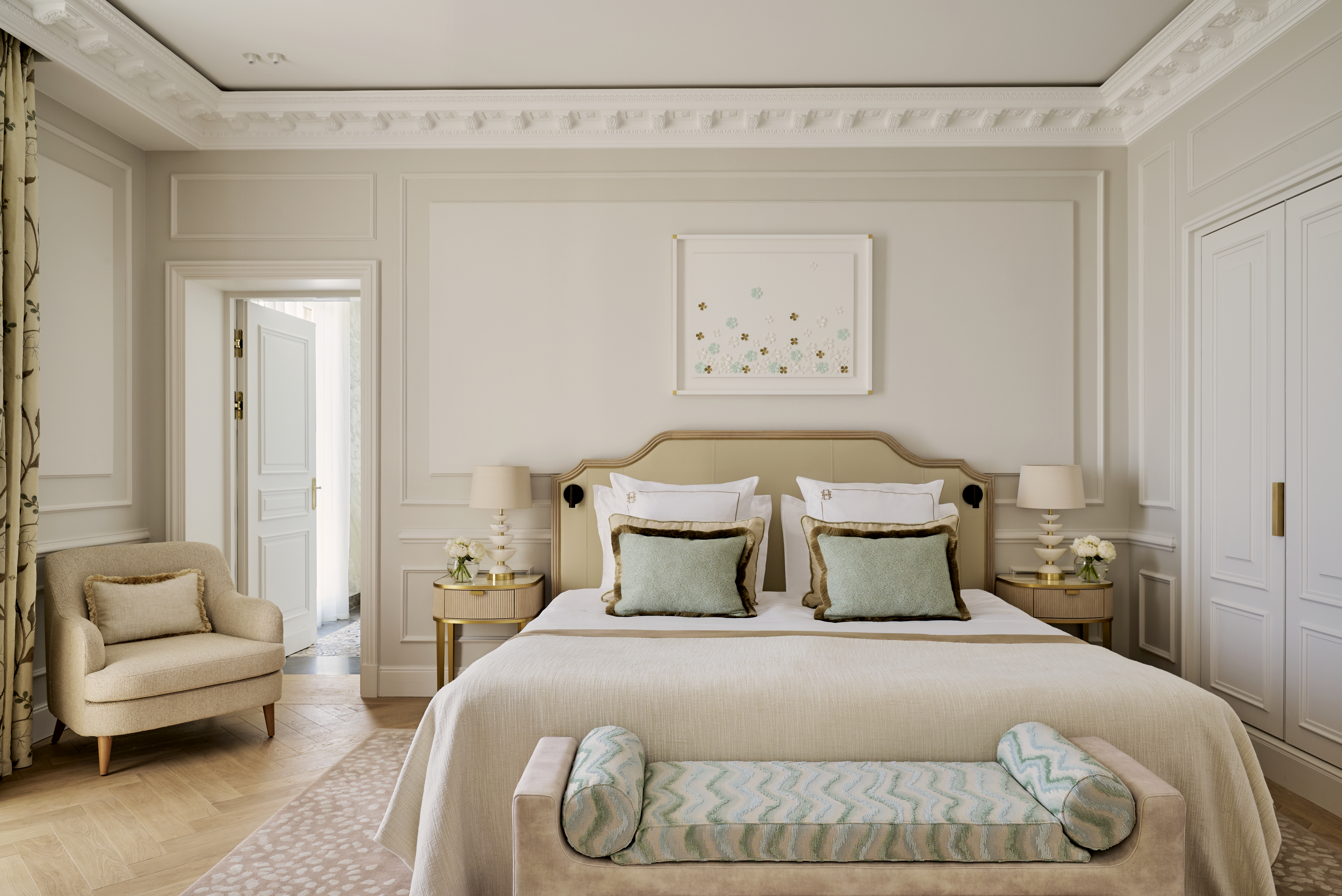 A luxury hotel suite in Monaco with a creamy palette that features accents of mint and aqua.