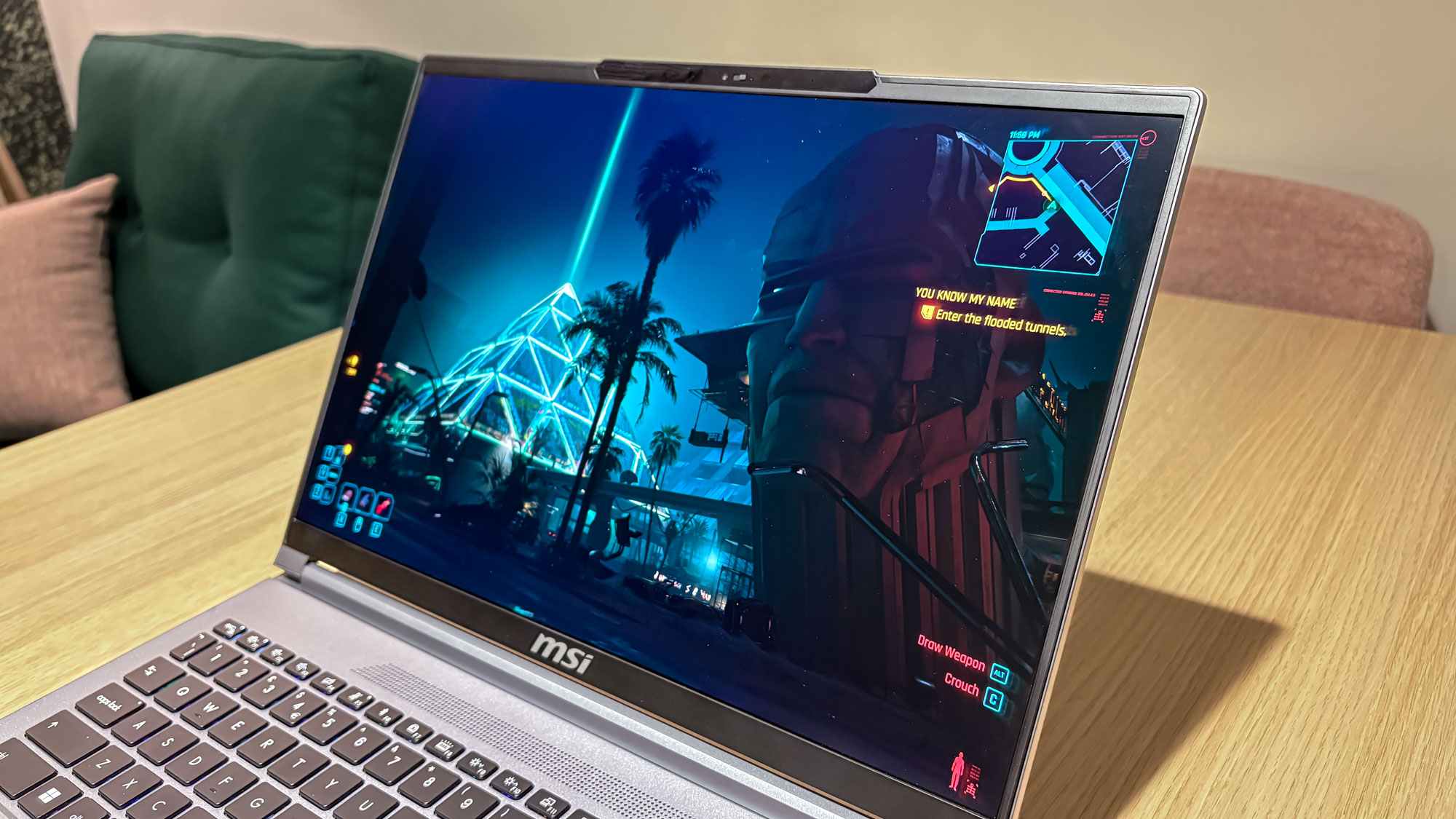 MSI Creator A16 AI+ on table with Cyberpunk 2077 showing on display