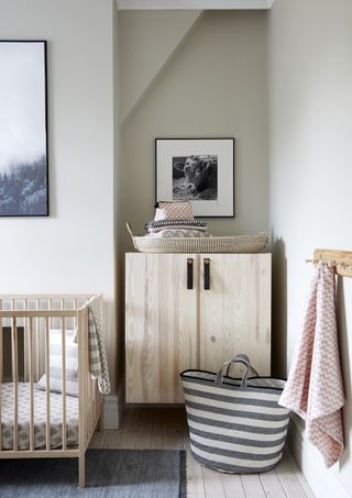 Scandi style nursery, gender neutral, pale blonde wood cot and wardrobe, gray walls