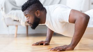 Man doing a push-up in a bid to tone up and lose weight on arms