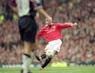 David Beckham scores a free-kick for Manchester United against West Ham in 2000.