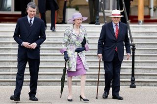 Princess Anne, Princess Royal arrives with Vice Admiral Sir Timothy Laurence (L) to attend the Not Forgotten Association Garden Party
