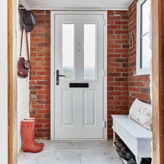 front porch with white door and shoe storage