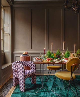 Dining table, vegetables, ferns, blue rug, candles