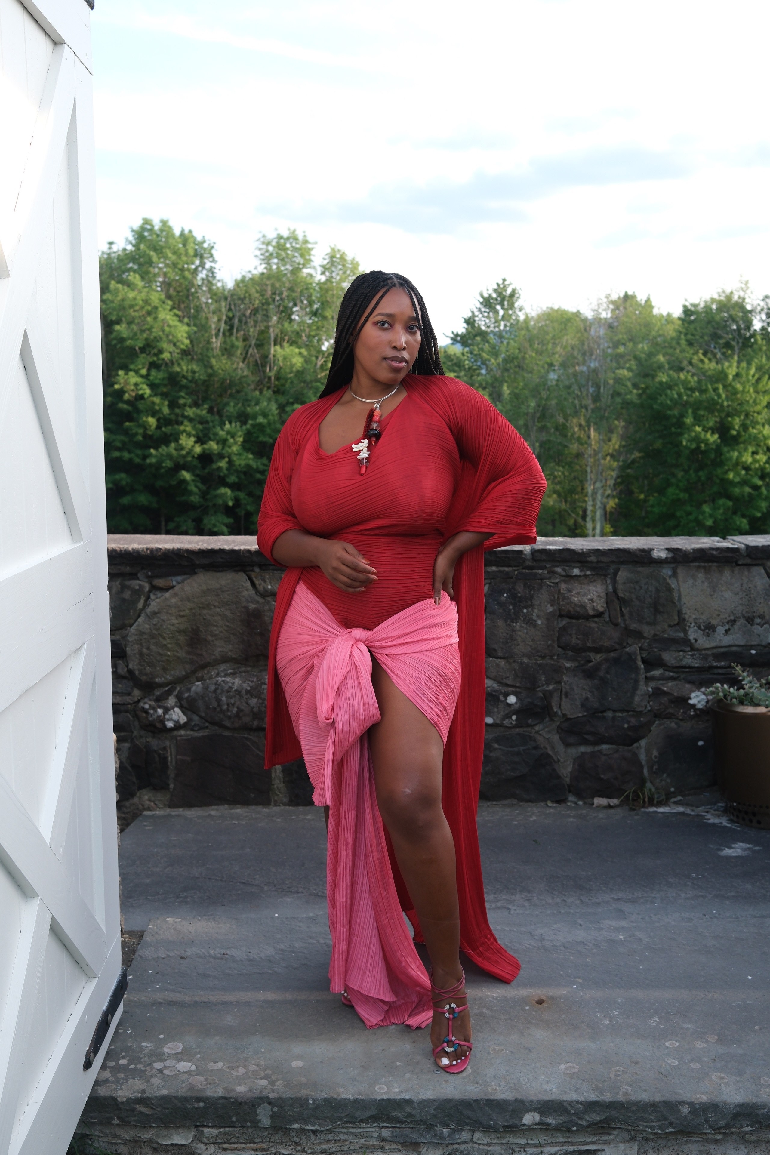 Mecca James-Williams in a pink and red wedding guest dress