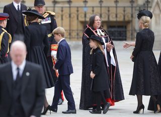Catherine, Princess of Wales, Princess Charlotte of Wales and Prince George of Wales arrive at Westminster Abbey for The State Funeral of Queen Elizabeth II on September 19, 2022 in London, England.