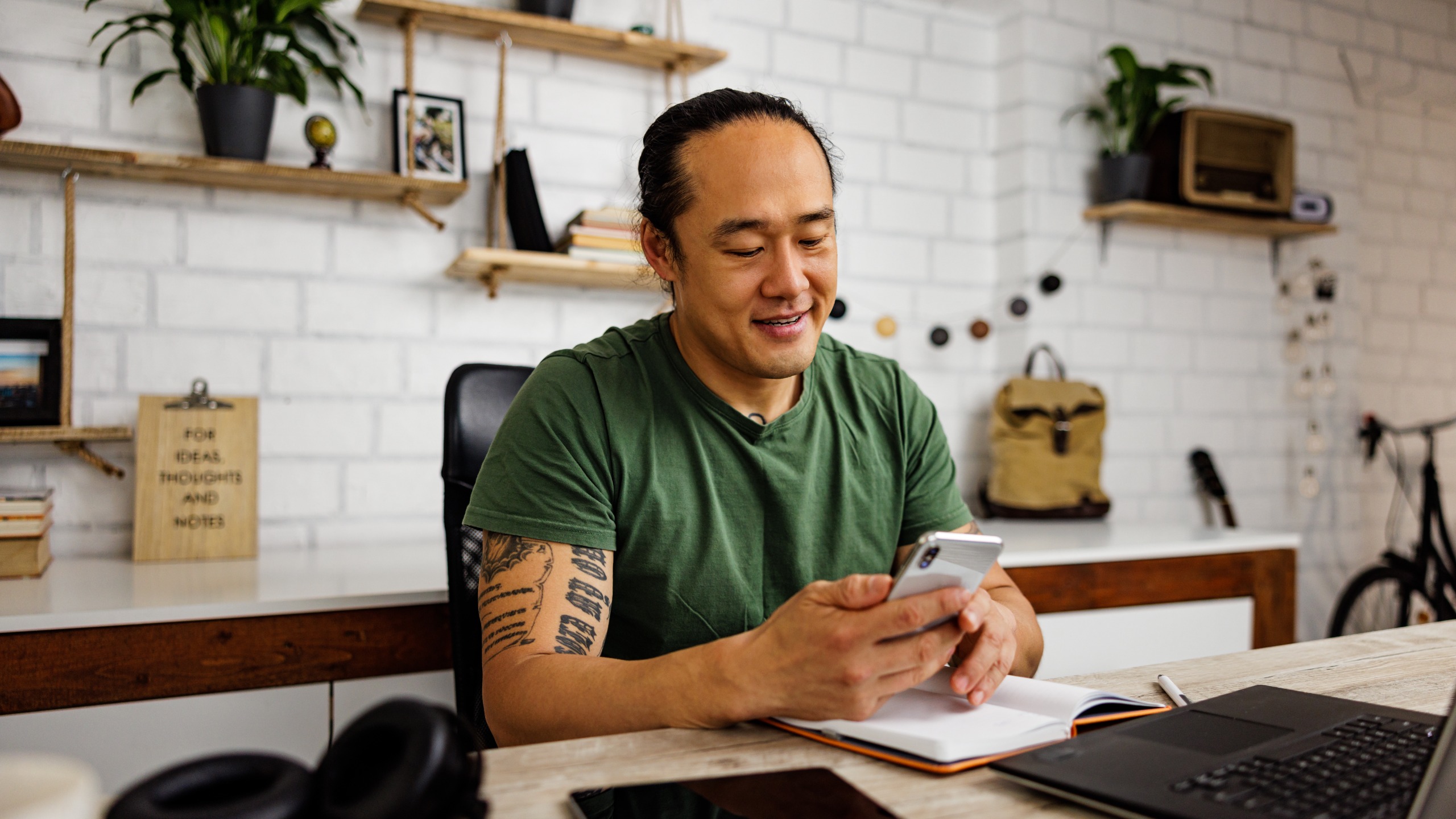 A man working from home uses an app to find a new job